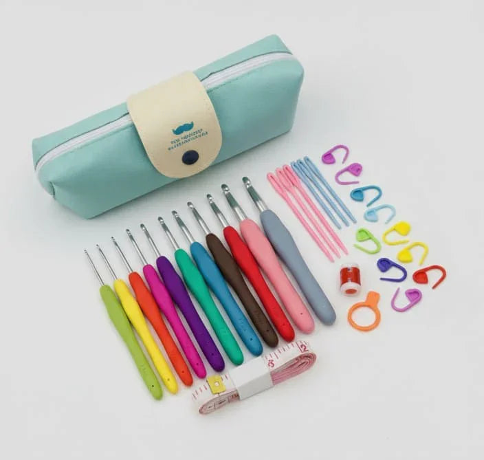 Colorful crochet hook set with accessories and blue carrying case on white background