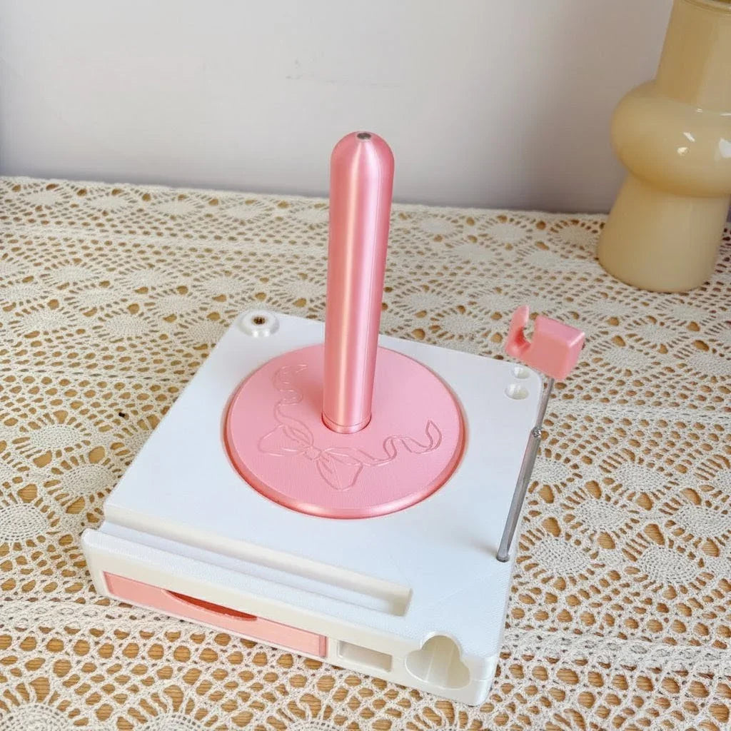 Pink and white tape dispenser with heart design on lace tablecloth