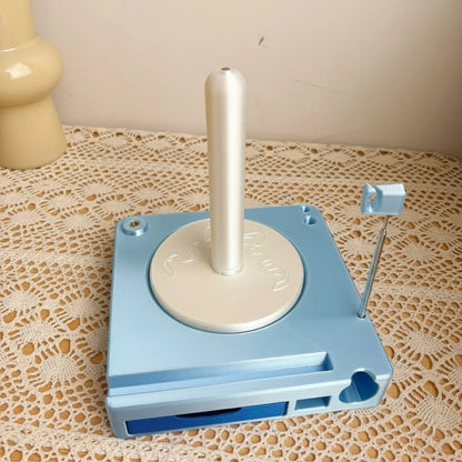 Light blue and white plastic golf ball dispenser on lace tablecloth, tabletop organizer